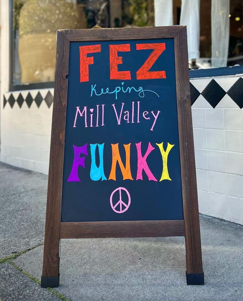 Aframe in front of store saying Fez Keeping Mill Valley Funky with a peace sign